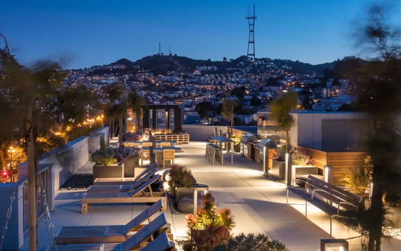 rooftop porch with recliner chairs and a view